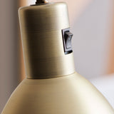 Close-up of the Angora Floor Lamp in antique brass, showing the brushed metal neck with black rocker switch and domed shade.