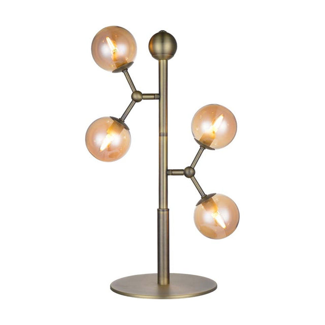 Atom Glass 4 Light Table Lamp in antique brass, with a slim stem and round base, four amber glass spheres branching at different heights, on a white background.