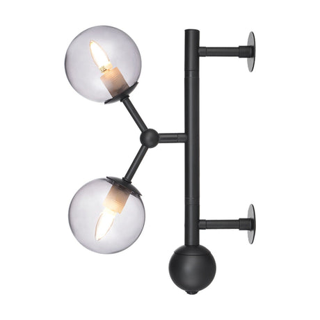 Atom Glass 2 Light Wall Light in black, featuring two smoked glass spheres on angled arms branching from a vertical bar with round wall plates, shown on a plain white background.