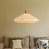 Paris Silk Pendant Light 72cm in Natural, a cream fabric shade with cone-and-drum shape, wood collar and brass detail, hung above a sofa in a living room setting.