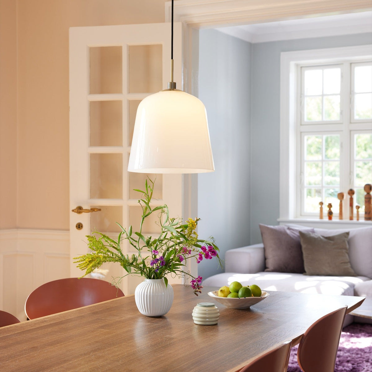 Room Pendant Light 30cm in opal glass with antique brass collar and black flex, shown above a dining table in a bright home setting.