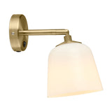 Room Wall Light in opal and antique brass, featuring a bell-shaped opal glass shade on a jointed brass arm with knurled collar, round wall plate and switch, shown on a plain white background.