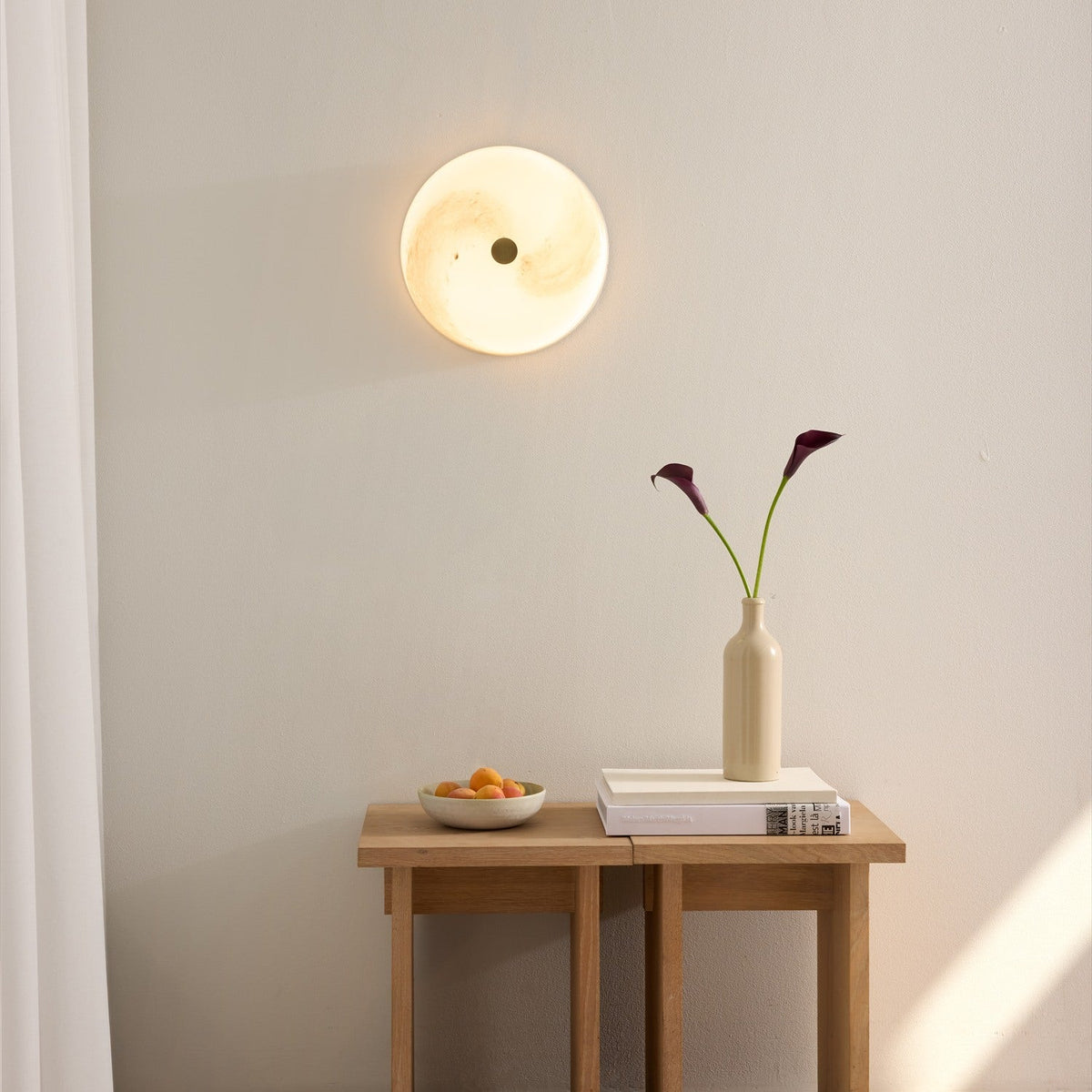 Stockholm LED Dimmable Flush Ceiling Light in grey marbled opal glass with brass centre boss, shown illuminated on a wall above a wooden console table.