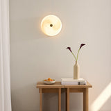 Stockholm LED Dimmable Flush Ceiling Light in grey marbled opal glass with brass centre boss, shown illuminated on a wall above a wooden console table.