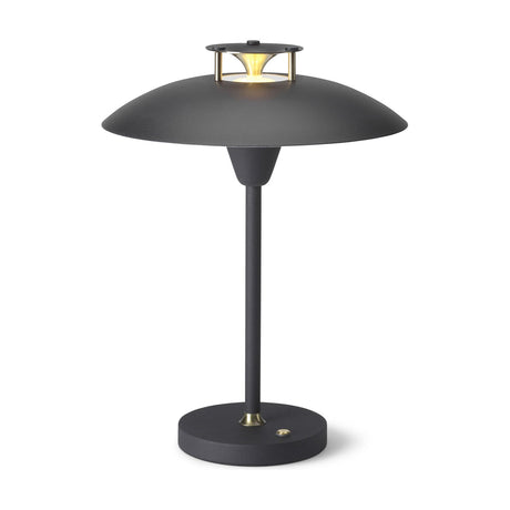 Stepp LED Outdoor Table Lamp in black, with a wide flat disc shade, brass cap and cone detail on top, slim stem, and round base, shown on a plain white background.
