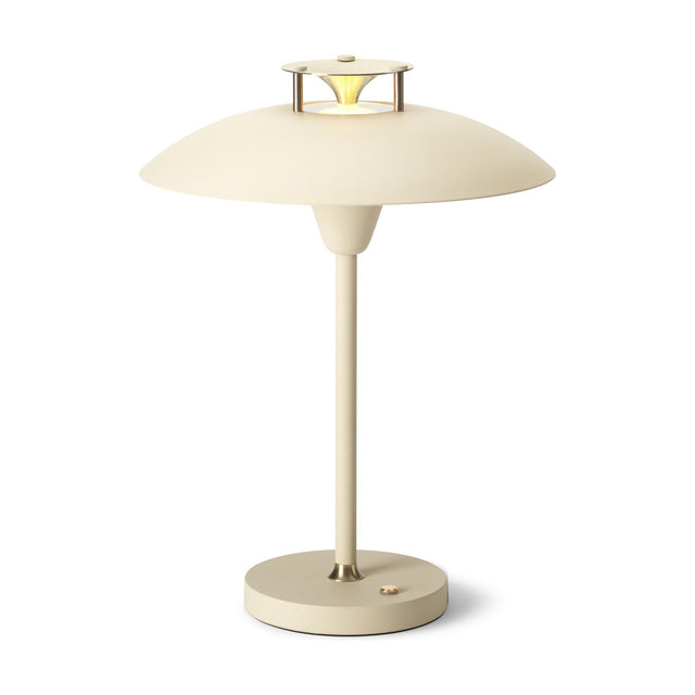 Stepp LED Outdoor Table Lamp in cream, featuring a wide flat disc shade with a stepped brass-accented cap, slim stem, and round base with power button, shown on a plain white background.
