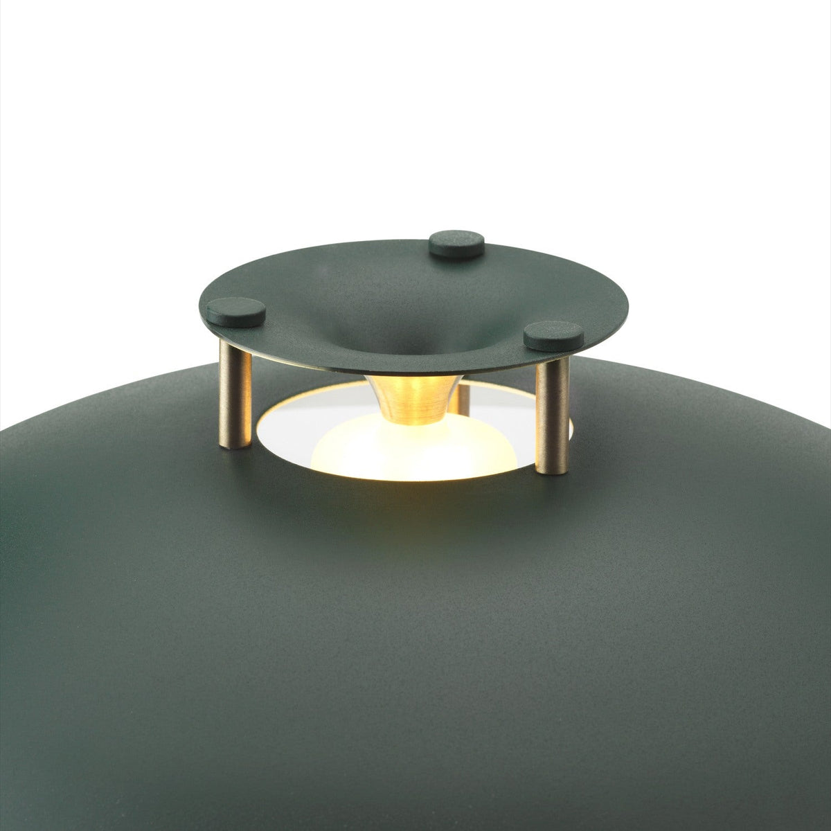 Close-up of the Stepp LED Outdoor Table Lamp in dark green, showing the shallow domed cap on brass posts with a glowing LED ring against the rounded body.