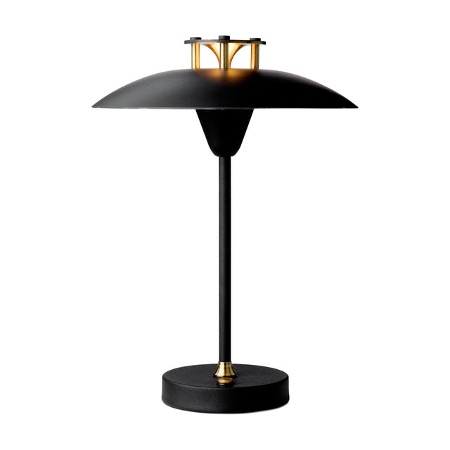 Mini Stepp LED Outdoor Table Lamp in black, with a wide flat disc shade, slim tapered stem, round base, and brass accents at the hub and base collar, shown on a white background.