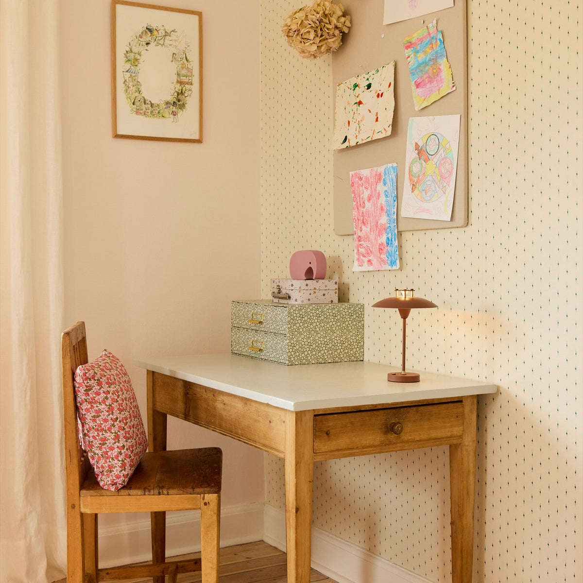 Mini Stepp LED Outdoor Table Lamp in terracotta with disc shade and slim stem, shown on a wooden desk in a child's bedroom styled with drawings and decor.