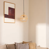 Stockholm Nordic Edition Pendant Light 30cm in natural bamboo with brass collar, shown hanging in a corner above a sofa beside a framed wall art.