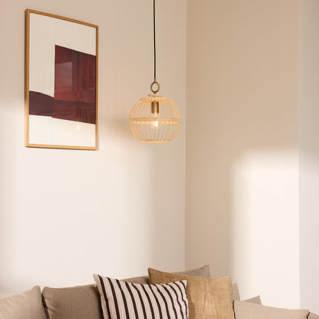 Stockholm Nordic Edition Pendant Light 30cm in natural bamboo with brass collar, shown hanging in a corner above a sofa beside a framed wall art.