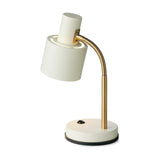 Vogue Table Lamp in cream with a cylindrical shade on a brass gooseneck arm, round cream base with black trim and switch, on a plain white background.