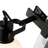 Close-up of the Glow Clip-On Table Lamp's black jointed arm and spring clamp with serrated jaws, shown against a plain white background.