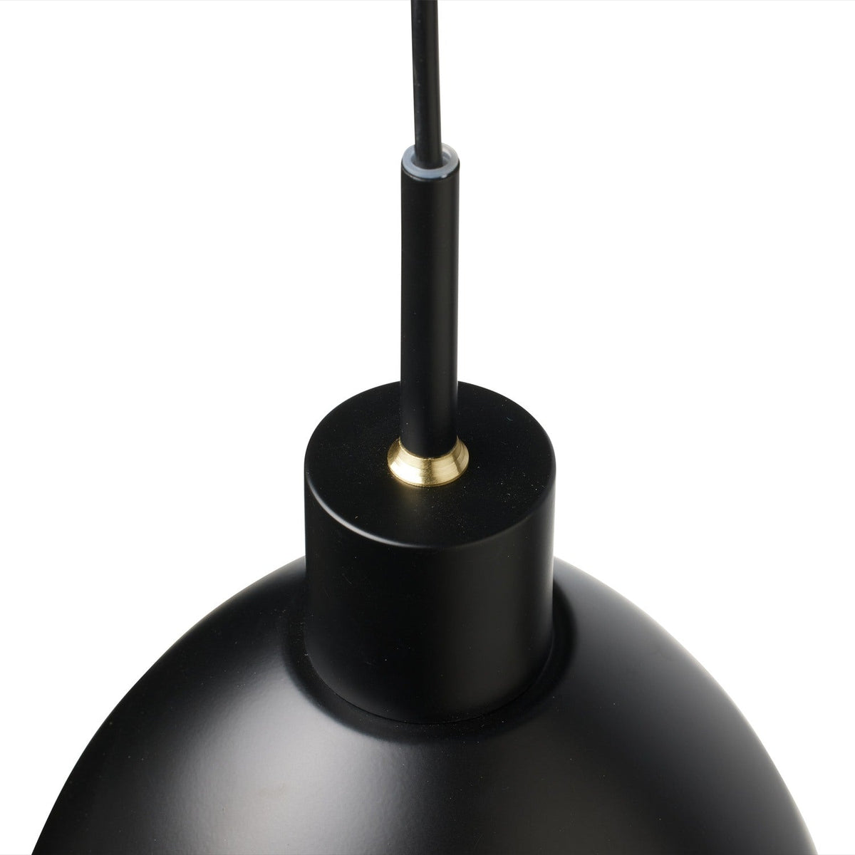 Close-up of the Rock Pendant Light 20cm in black, showing the matt shade's cylindrical top with brass detail and black cord against a plain white background.