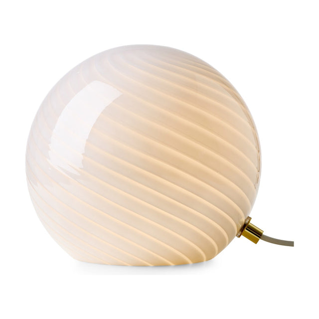 Candy Table Lamp 20cm in opal glass, a spherical globe with a spiral flute pattern and small brass collar fitting, glowing warm amber against a plain white background.
