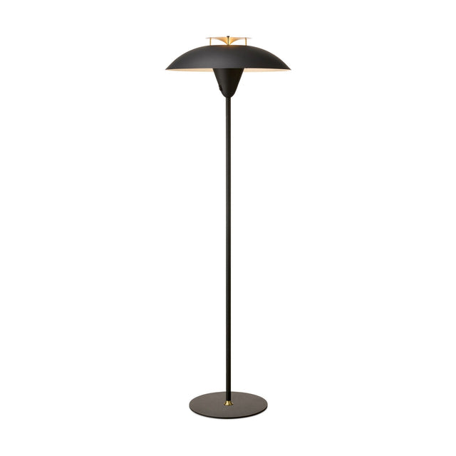 Stepp Floor Lamp in black with a wide shallow dome shade, antique brass fin detail at centre, slim stem and round base, shown on a plain white background.