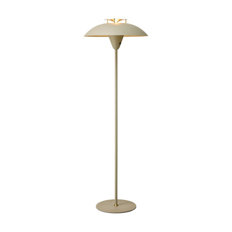 Stepp Floor Lamp in sand with a wide shallow disc shade, antique brass fin detail at centre, slim stem, and round base, shown on a plain white background.