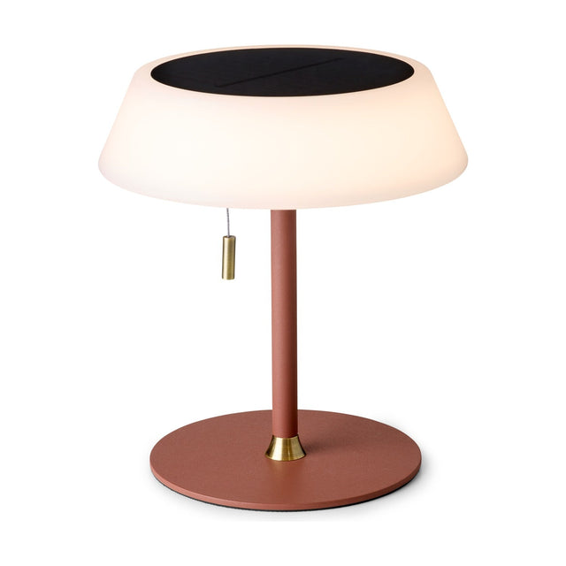 Solar LED Portable Outdoor Table Lamp in terracotta, with a wide opal drum shade topped by a black solar panel, brass pull toggle, and round terracotta stem and base on a white background.