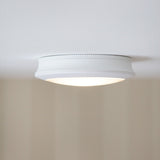 Push Rechargeable Flush Ceiling Light 18cm with Sensor in white, a round fitting with ribbed edge and prismatic diffuser, mounted flush on a plain white ceiling.