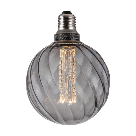 Colors Twist 5W 3-Step Memory Bulb 125mm in smoke glass, a large round E27 globe with twisted flute ribs, visible filament, and a dark knurled collar on a plain white background.
