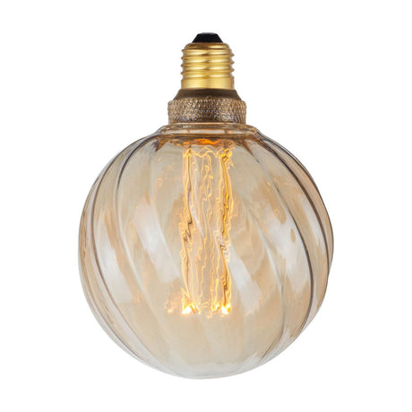 Colors Twist 5W 3-Step Memory Bulb, 125mm globe in amber glass with twisted fluted ribs, E27 brass fitting, glowing filament visible, shown on a plain white background.