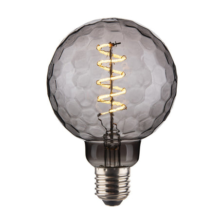 Colors Geo 3-Step Memory Bulb 95mm in smoked grey glass with faceted honeycomb surface, spiral LED filament, E27 base, on a plain white background.