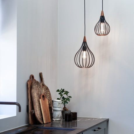 Drops Pendant Light 30cm in black wire teardrop-shaped cage with dark wood cap, shown with a second unit in a kitchen setting above a wooden countertop.