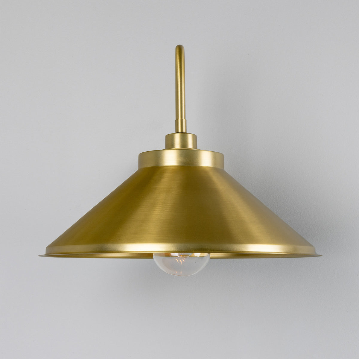 Halvery Brass Swan Neck Wall Light IP65 with curved arm and wide cone shade over a single exposed bulb, shown against a plain light grey background.