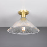 Hanoi Ribbed Glass Flush Ceiling Light with a cone-shaped prismatic glass shade and brass ceiling plate, shown with an exposed E27 bulb against a plain grey background.