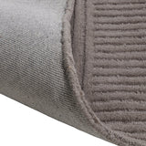 Haraan Rug 180 x 120cm folded corner showing brown wool ridged pile with woven grey backing, revealing carved panel texture and edge finish.