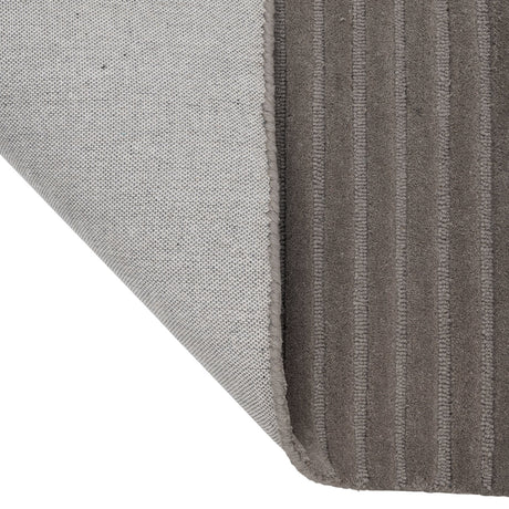 Haraan Rug 230 x 160cm in brown wool, corner folded back to reveal the ribbed striped pile and woven grey backing.