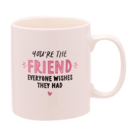 White porcelain mug with rounded handle, printed with "You're the friend everyone wishes they had" in black and pink lettering with a small heart, on a plain background.