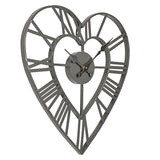 Open frame heart-shaped wall clock in matt grey iron, with bold Roman numerals on the outer heart and a smaller heart around the central hub, shown on a plain white background.