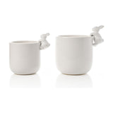 Set of two round white ceramic planters in different sizes, each with a small bunny perched on the rim, paws over the edge, shown on a plain white background.