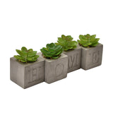Set of 4 Home Cube Cement Pot Faux Plants, grey stone-finish cubes engraved H-O-M-E, each holding a green succulent with pebbles, on a plain white background.