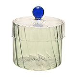 Round handmade glass trinket box with ribbed pale green base, clear ribbed lid, and a blue glass ball knob, shown on a plain white background.