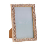 Rectangular wooden photo frame with brown and white chevron stamped pattern, holding a 6 x 4in print, shown on a plain white background.