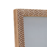 Close-up corner view of the Chevron Stamped Wood Photo Frame 6 x 4in, showing brown and white zigzag pattern with natural wood edges, on a white background.
