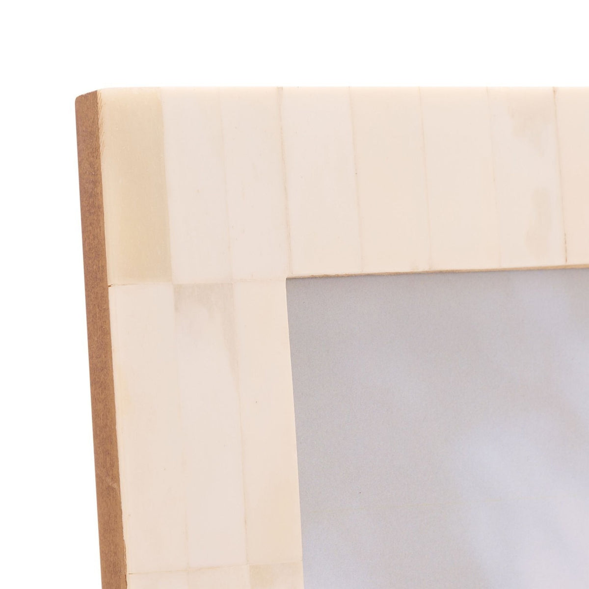 Close-up of the Wide Border Bone Photo Frame corner, showing white tiled bone segments with subtle graining over a brown edge and backing, set against a plain white background.