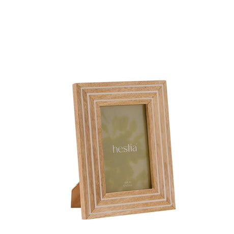 Natural wood photo frame with fine white striped detailing and built-in stand, shown at an angle on a plain white background with a sample 6x4in portrait insert.