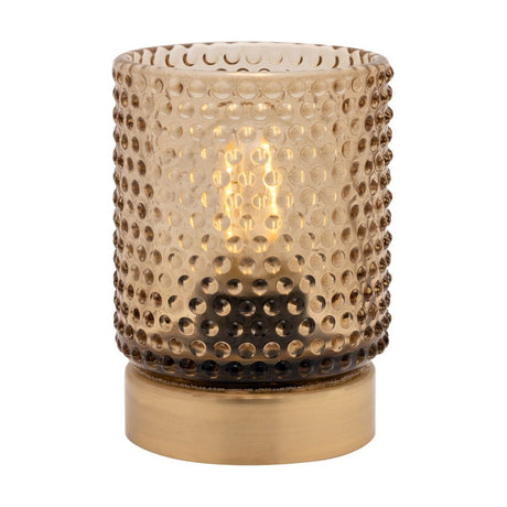 Glass cup table lamp with smoky amber hobnail-textured shade on a plain gold base, LED bulb visible inside, shown on a white background.