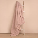 Pink Square Teddy Throw, 150cm x 150cm, in curly plush texture draped over a white ladder against a plain pink background.