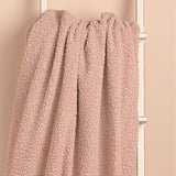 Pink Square Teddy Throw, 150cm x 150cm, in plush curly-textured fabric, draped over a white ladder against a soft pink wall.