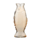 Tall clear glass fish vase standing on its tail, with a round eye, curved gill line, wavy side fins and a notched mouth-shaped rim, shown against a plain white background.