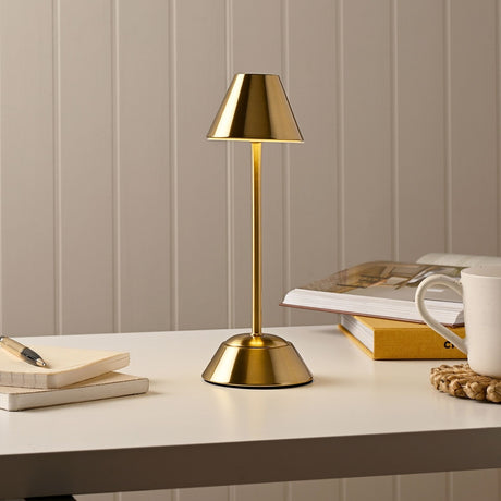 Slim Tapered Shade USB LED Touch Table Lamp, 28.5cm, bronze finish with tapered shade and sloping round base, shown on a desk beside books, a notepad and a mug.