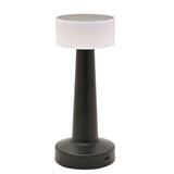 Matt black LED touch table lamp with a white round drum shade on a tapered stem and wide round base, USB port on the back, shown on a plain white background.