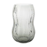 Tall hourglass glass vase with ribbed, rippled texture in clear glass with a smoky grey tint deepening towards the base, shown on a plain white background.