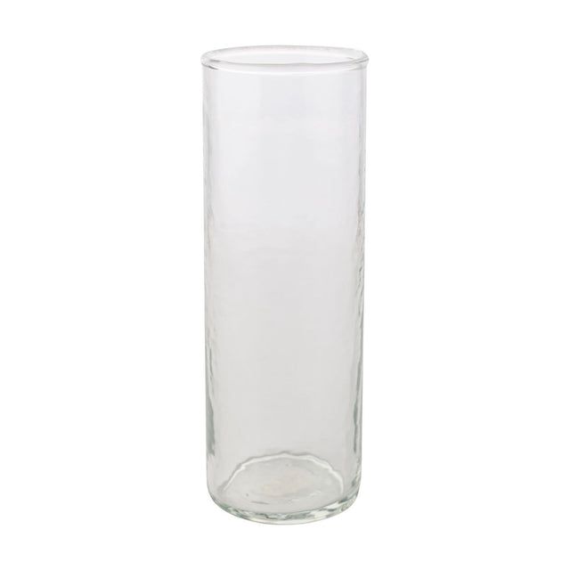 Tall straight-sided hammered style drinking glass in clear glass with a round base and smooth rim, shown on a plain white background.