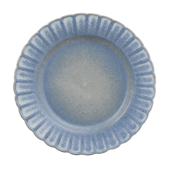 Small round stoneware plate with a fluted rim and scalloped edge, finished in a speckled blue glaze fading to grey-blue at the centre, shown on a plain white background.