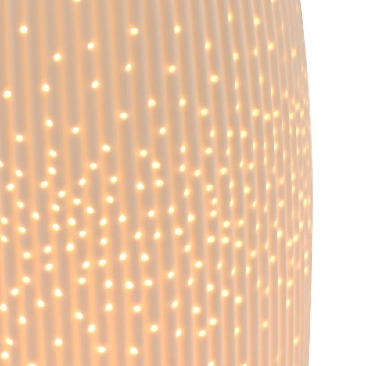 Close-up of the Tall Oval Ribbed Pierced Dot Ceramic Table Lamp in white, showing vertical ribs and illuminated pierced dots glowing from within.